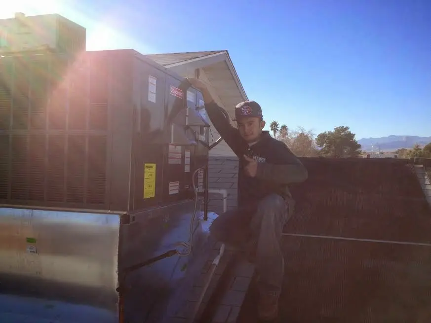 HVAC technician performing HVAC Inspection on a rooftop unit in Spring Valley Lake